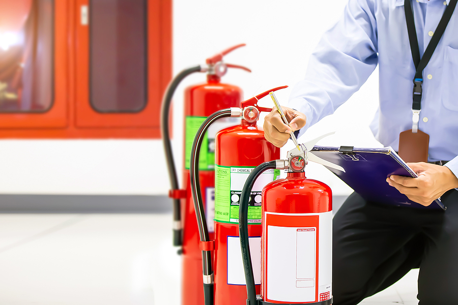 Fire extinguisher, Firefighter use inspection list checking pressure gauge level of fire extinguisher tank in the building of protection and prevent for emergency and safety rescue and fire training.